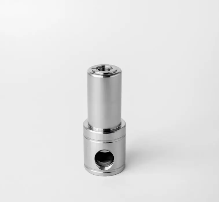 A metal piston guide component for pumps, featuring a cylindrical shape with side holes and a threaded top, displayed on a white background.